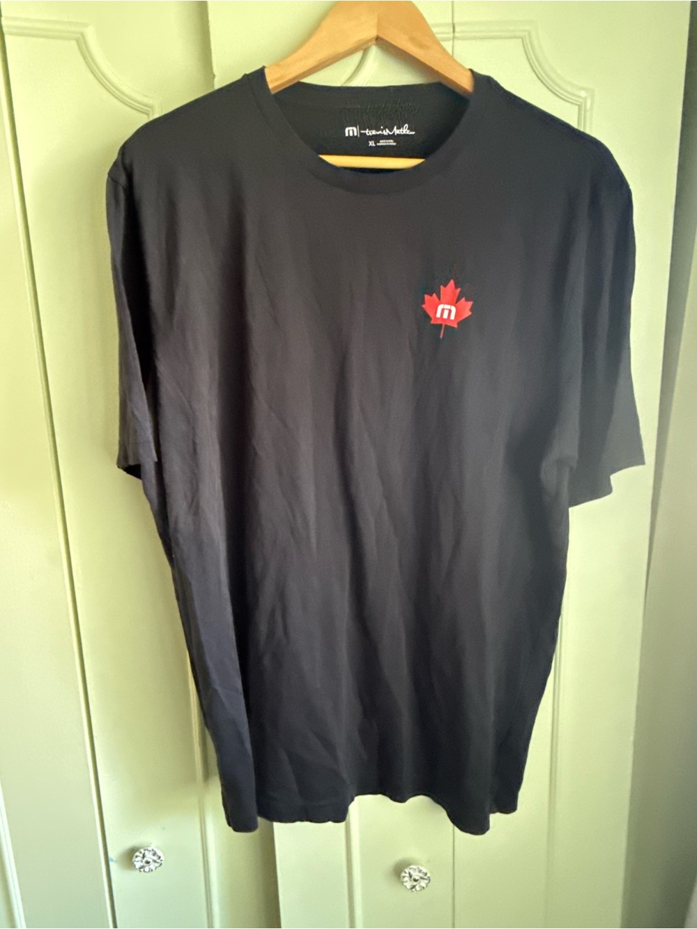 Travis Mathew Black Short Sleeve Tee with Red Maple Logo